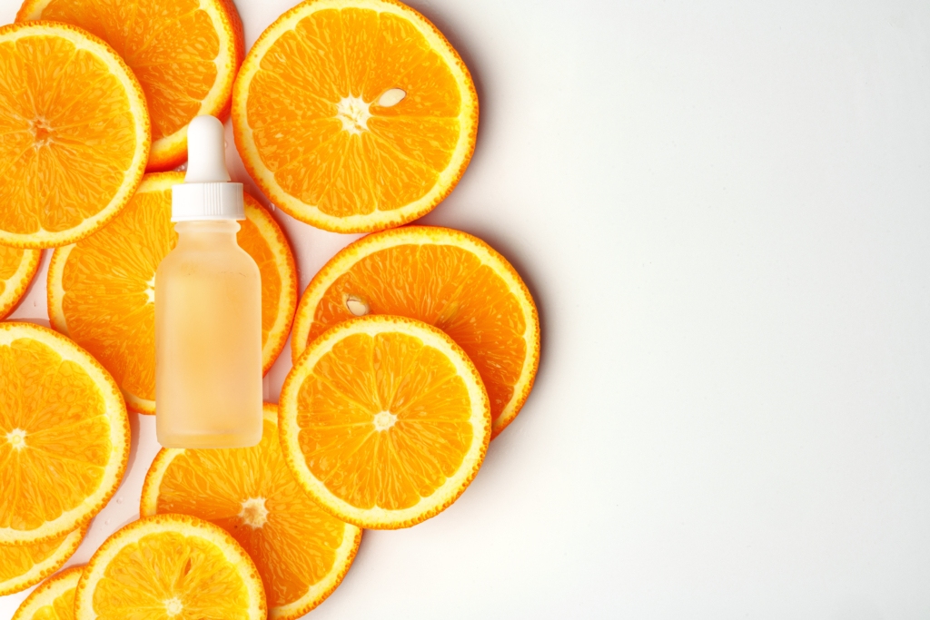 Skincare bottle on stacked orange slices